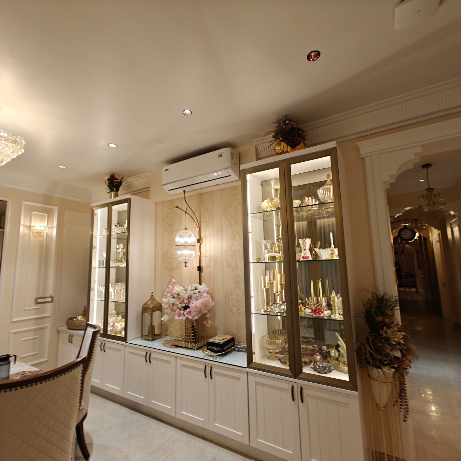 Backlit display cabinet with gold accents — INKA interior joinery